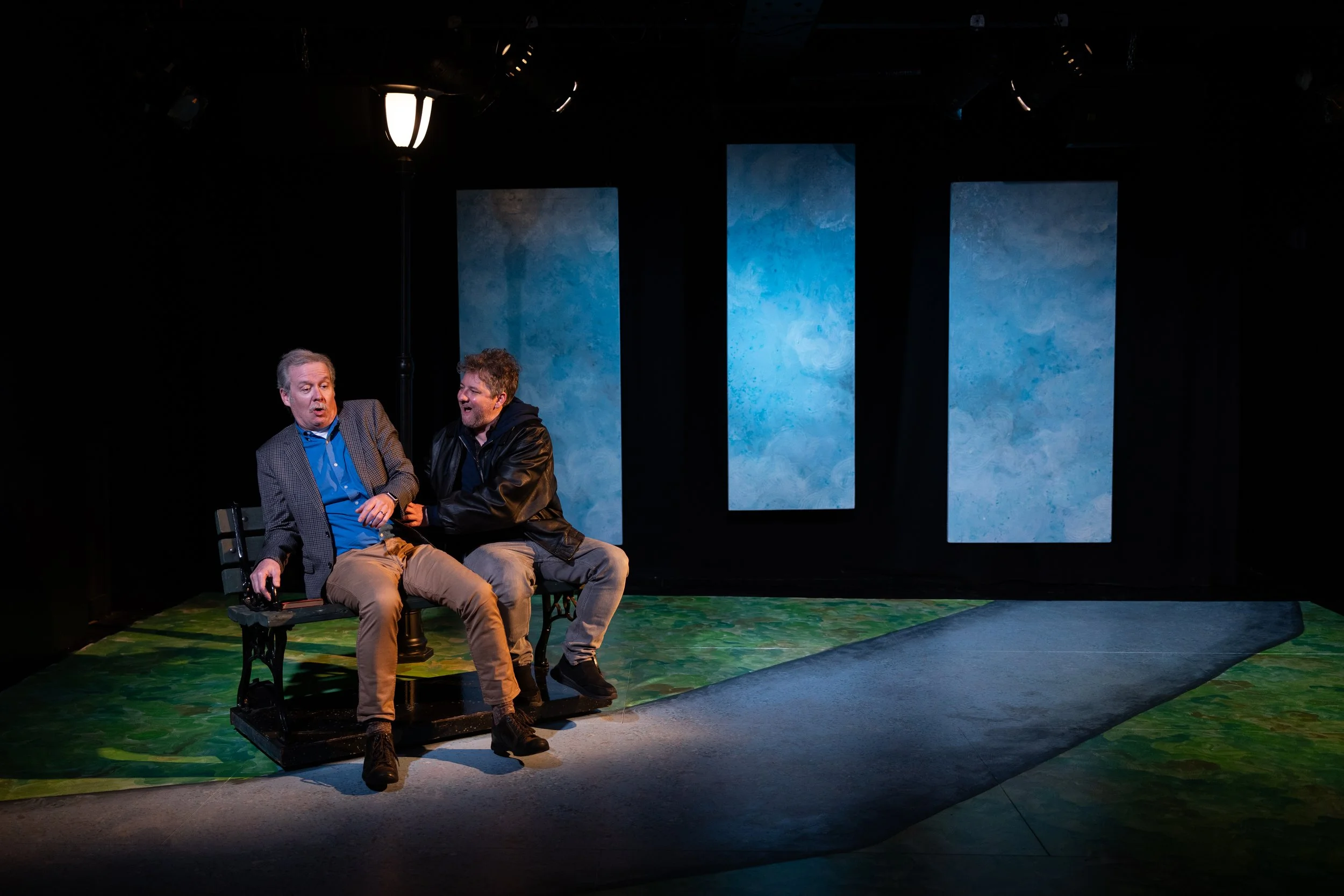 Two actors on a park bench in a Mainstage production