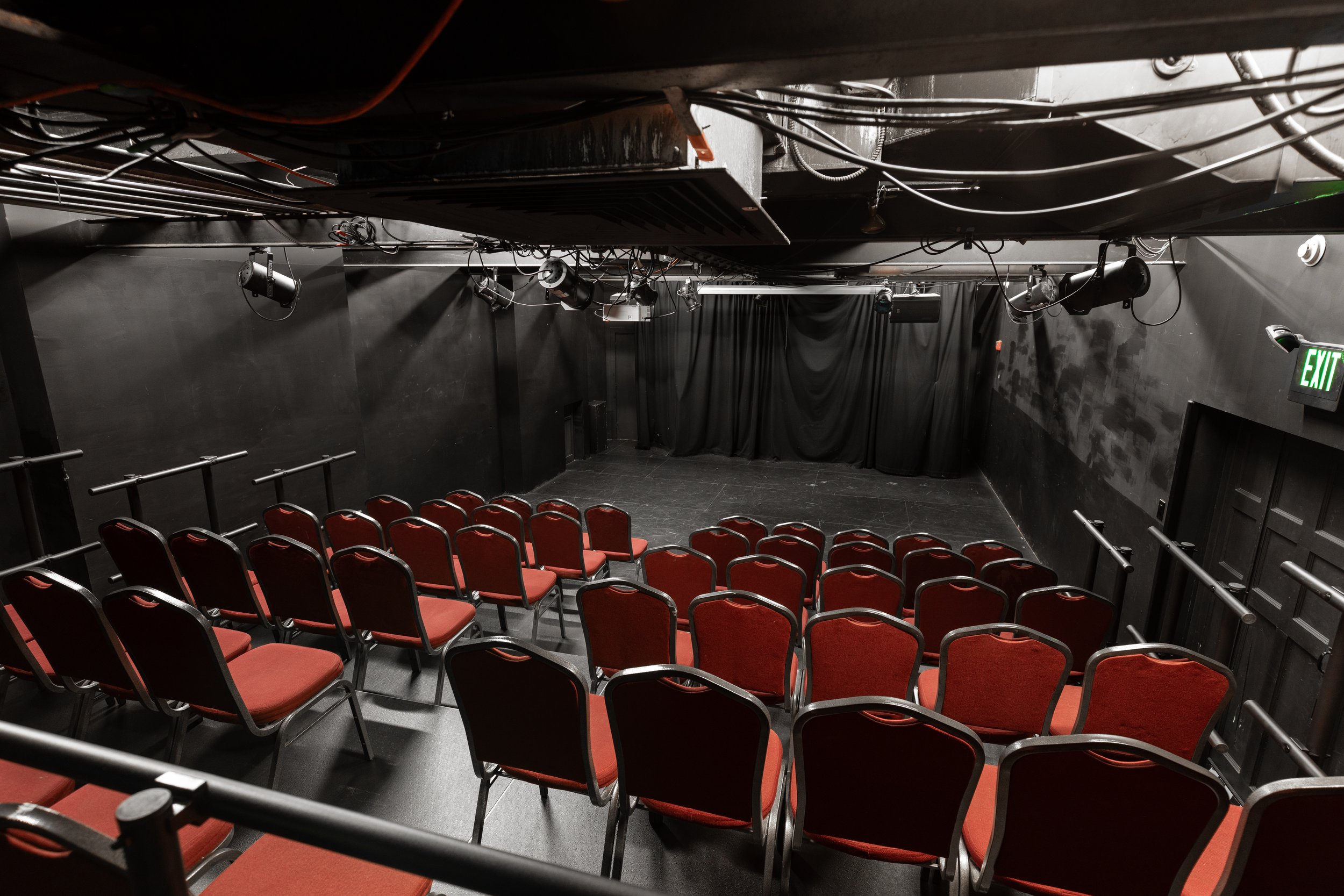 Skinner Studio black box with red riser seats and black curtain